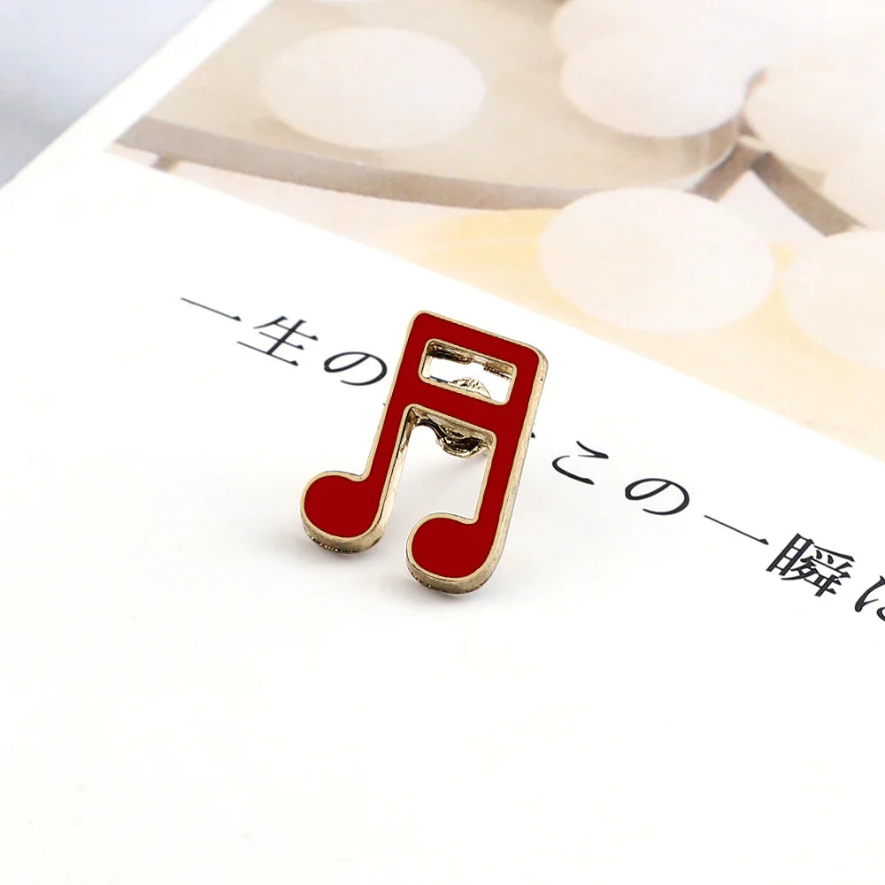 A vibrant red music note enamel pin with gold-tone outline ideal for fashion guitar microphone and piano notes lapel use
