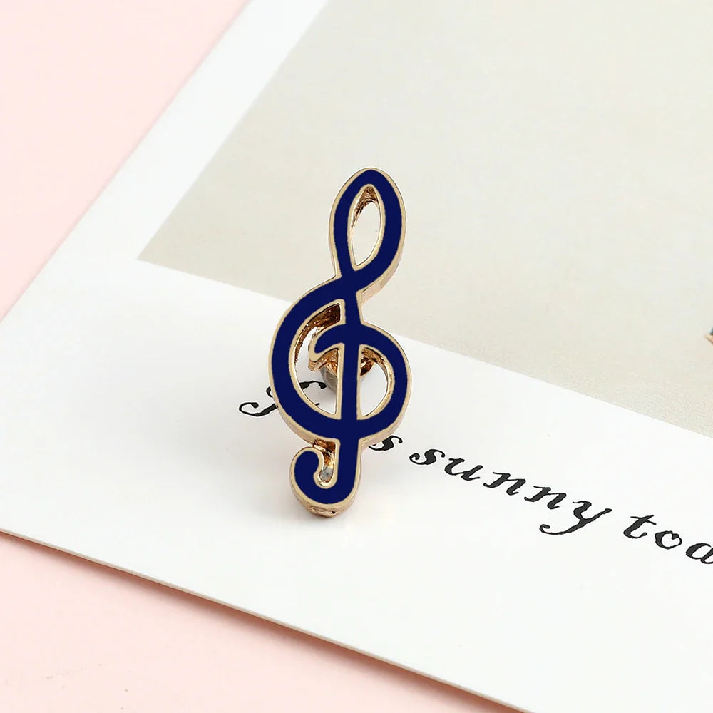 A navy blue and gold enamel treble clef music note enamel brooch ideal as a piano notes lapel pin gift