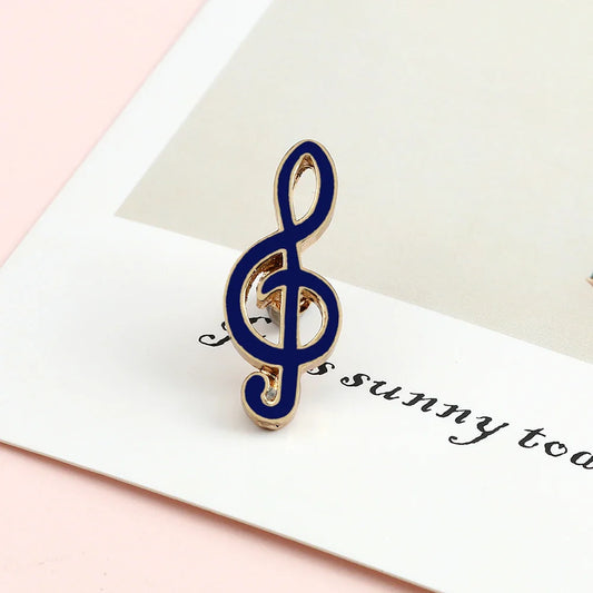 A navy blue and gold enamel treble clef music note enamel brooch ideal as a piano notes lapel pin gift