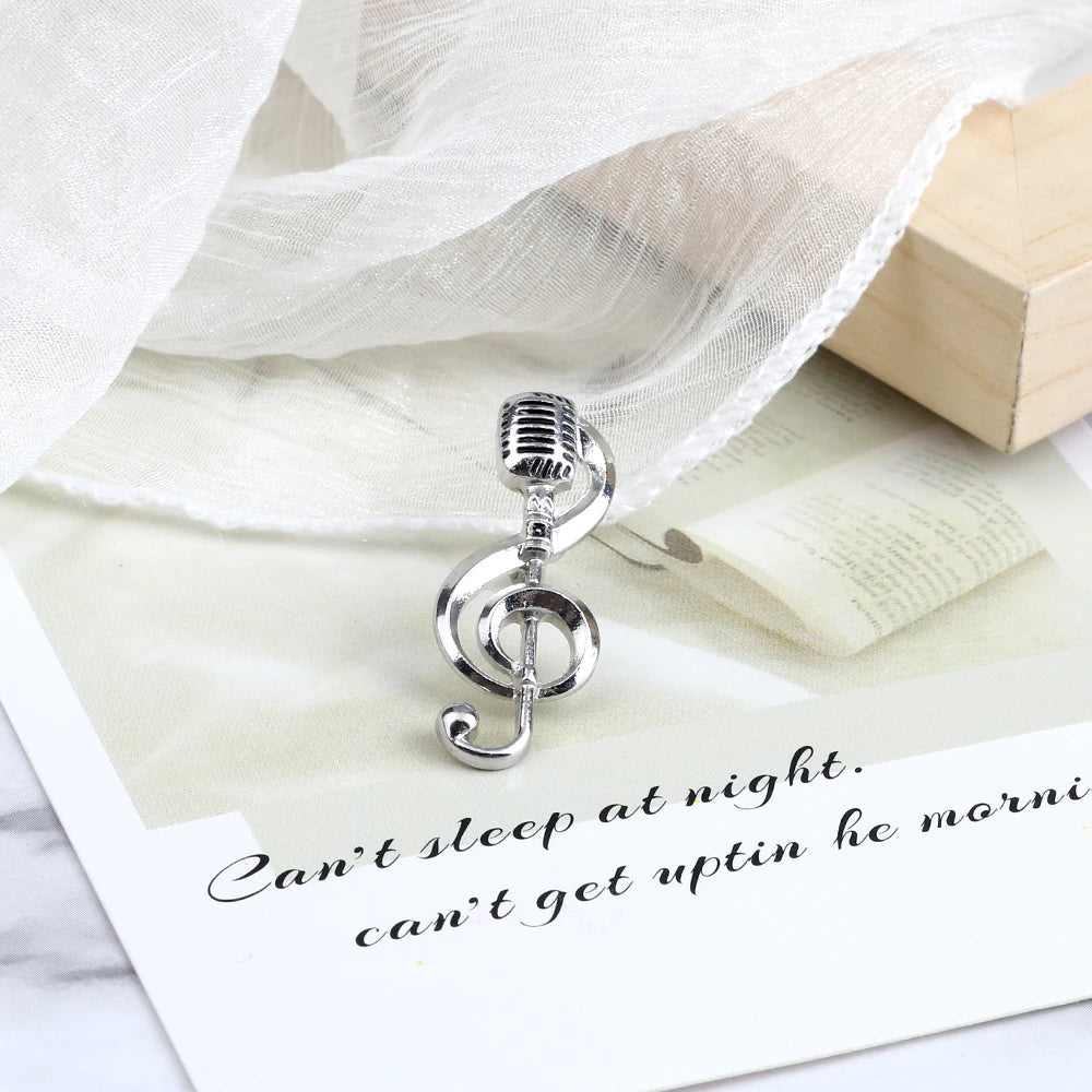 Silver microphone shaped charm with treble clef design crafted from metal for music note enamel and piano notes lapel use