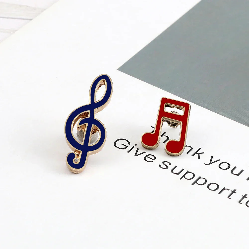 Blue and red enamel music note enamel pin badges featuring treble clef and eighth note designs for musician gifts