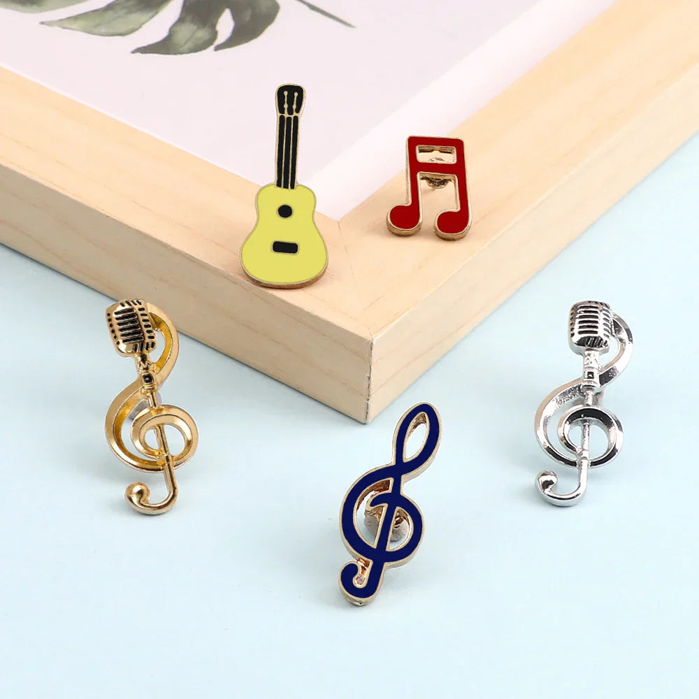 Yellow guitar-shaped music note enamel pin with black strings and gold-tone clasp for piano notes lapel accessory