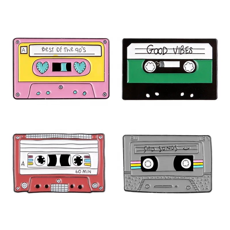 Four colorful enamel cassette tape pins featuring creative music symbol designs on a headset alloy brooch badge