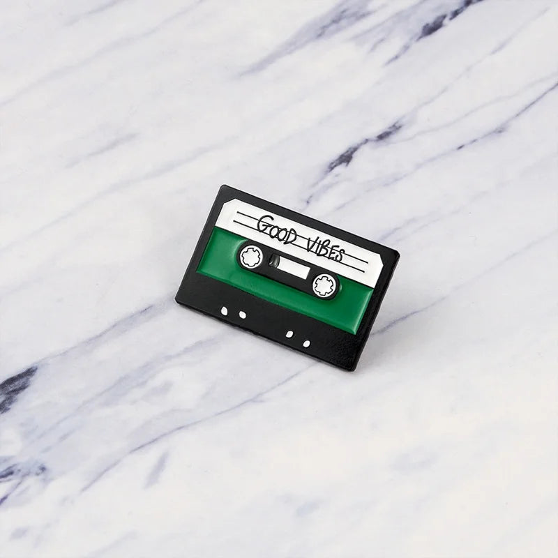 Green and black enamel cassette tape pin with good vibes text creative music symbol piano cd graphophone headset alloy brooch