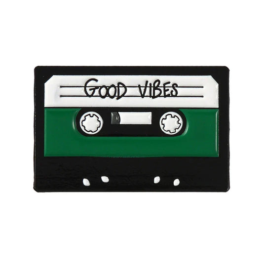 Creative music symbol enamel pin shaped like a green and black cassette tape with good vibes label in alloy brooch style