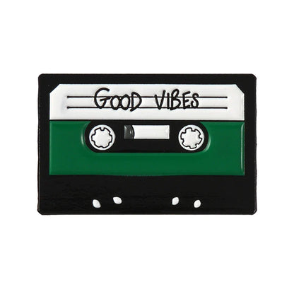 Creative music symbol enamel pin shaped like a green and black cassette tape with good vibes label in alloy brooch design