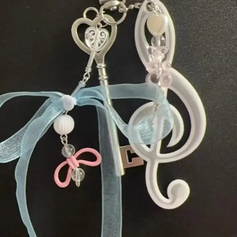Delicate silver note keychain bowknot with heart design pink clear beads attached to light blue ribbon for backpack pendant theater use