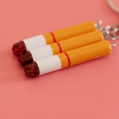Three orange cigarette key chains with white bands and red stripes made of creative simulation pvc for bag pendant accessories