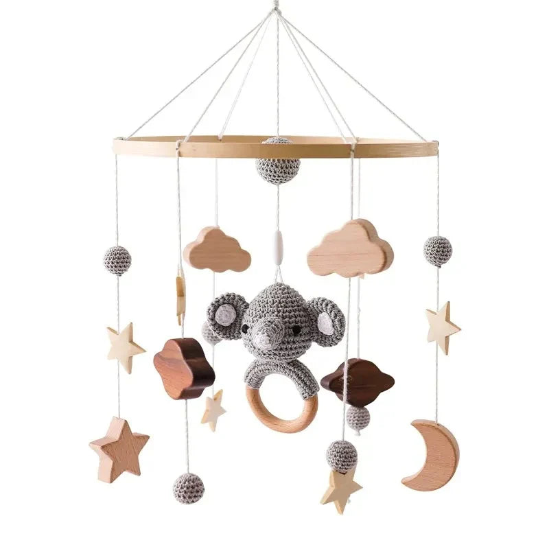 Gray crocheted koala crib bell rotary music box with wooden ring and natural wood accents promotes hand-eye coordination