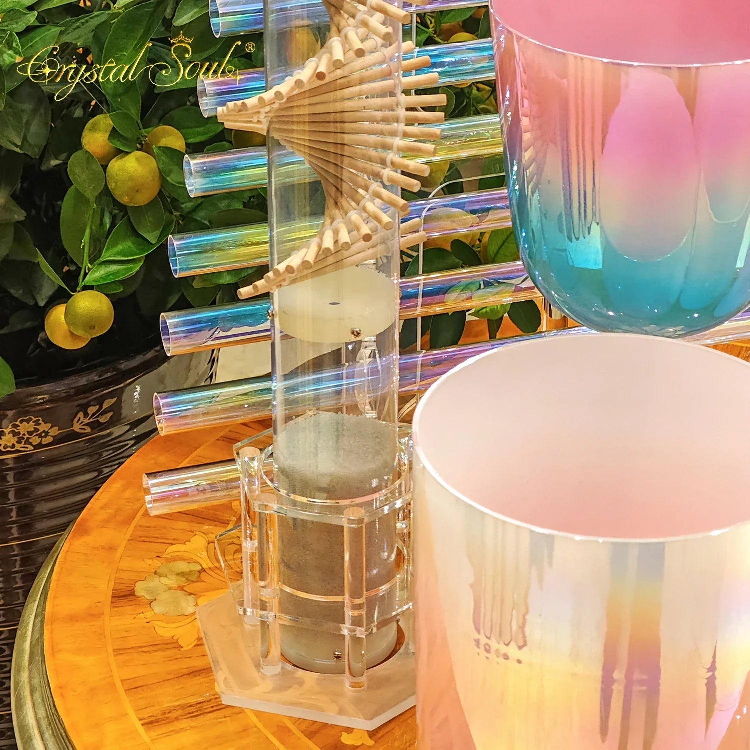 A sleek iridescent glass chime tower with spiral wooden dowel and acrylic supports for crystal soul essential sound therapists