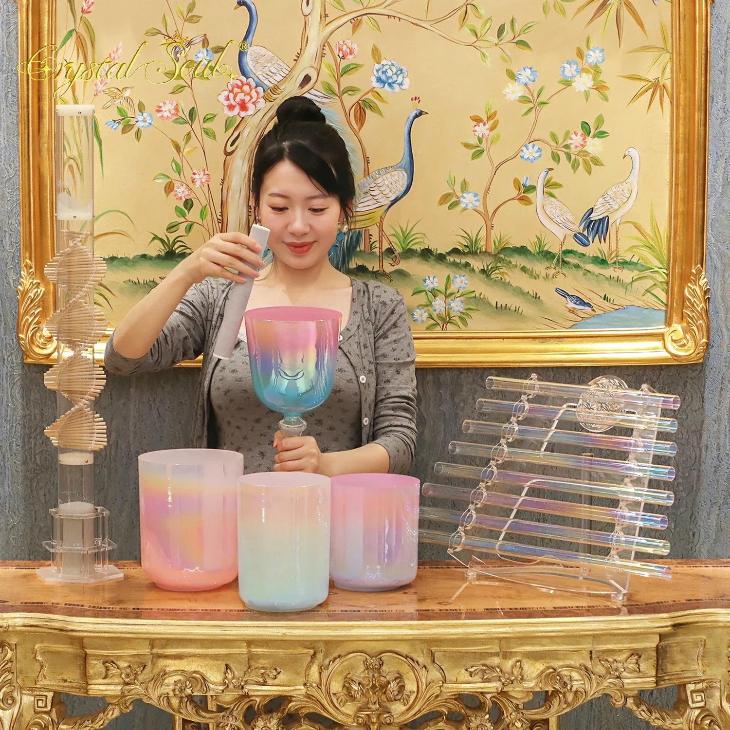 A vibrant iridescent glass singing bowl with pink to blue hues and smiling face design for crystal soul essential sound therapists essential instrument use