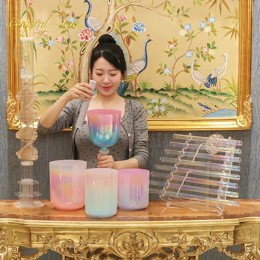 A vibrant iridescent glass singing bowl with pink to blue hues and smiling face design for crystal soul essential sound therapists essential instrument use