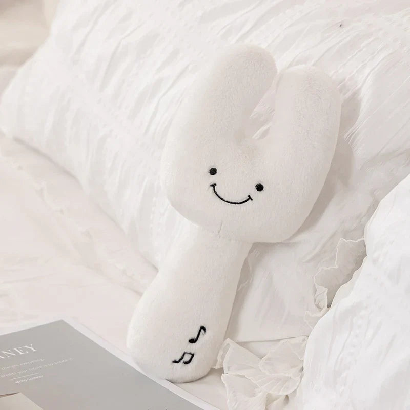 White plush bunny-shaped cute musical plush toy with embroidered smiley face and musical note design gift for kids