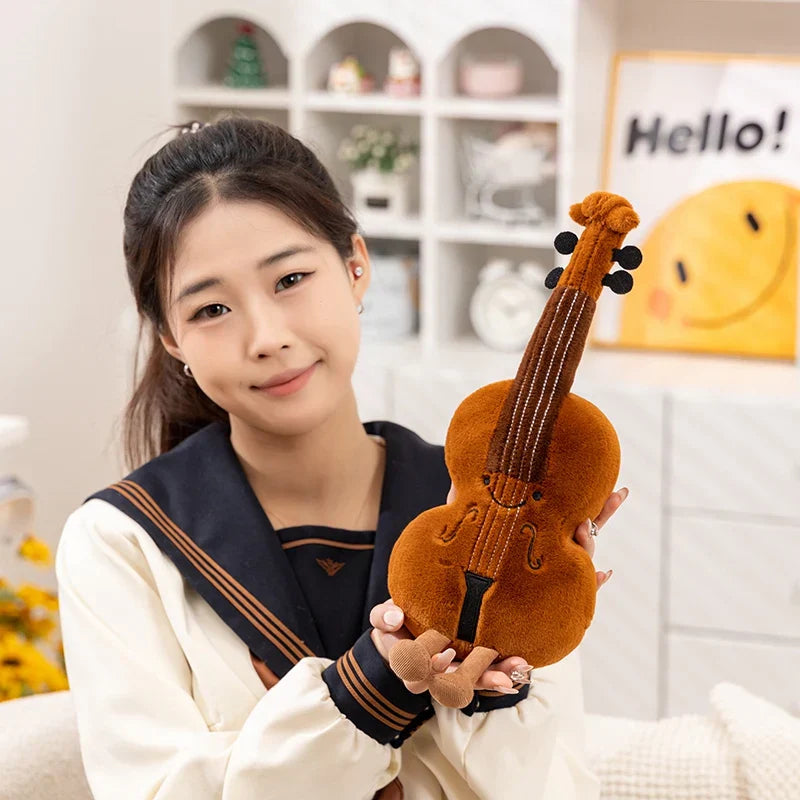 A cute musical plush brown toys soft violin with embroidered details and fuzzy texture perfect for music lover gifts