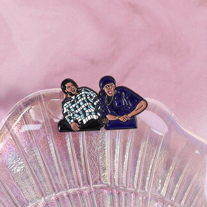 A glossy enamel pin featuring friday chris tucker characters in checkered and blue outfits for hip hop music fans
