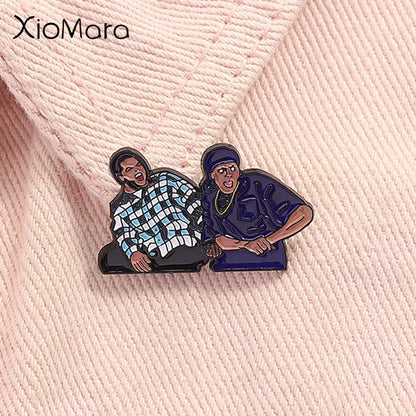 Xiomara brand enamel pin featuring two cartoon characters in plaid and navy outfits inspired by friday chris tucker hip hop music