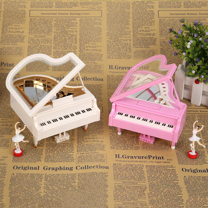 Elegant music box featuring white and pink miniature pianos with gold accents and dancing ballerina figurines ideal as birthday wedding gift