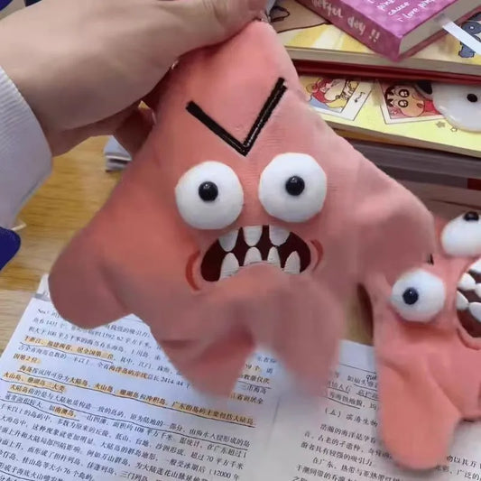 Pink plush monster hand puppet with googly eyes and sharp teeth as a cute moving meteor pendant doll backpack ornament