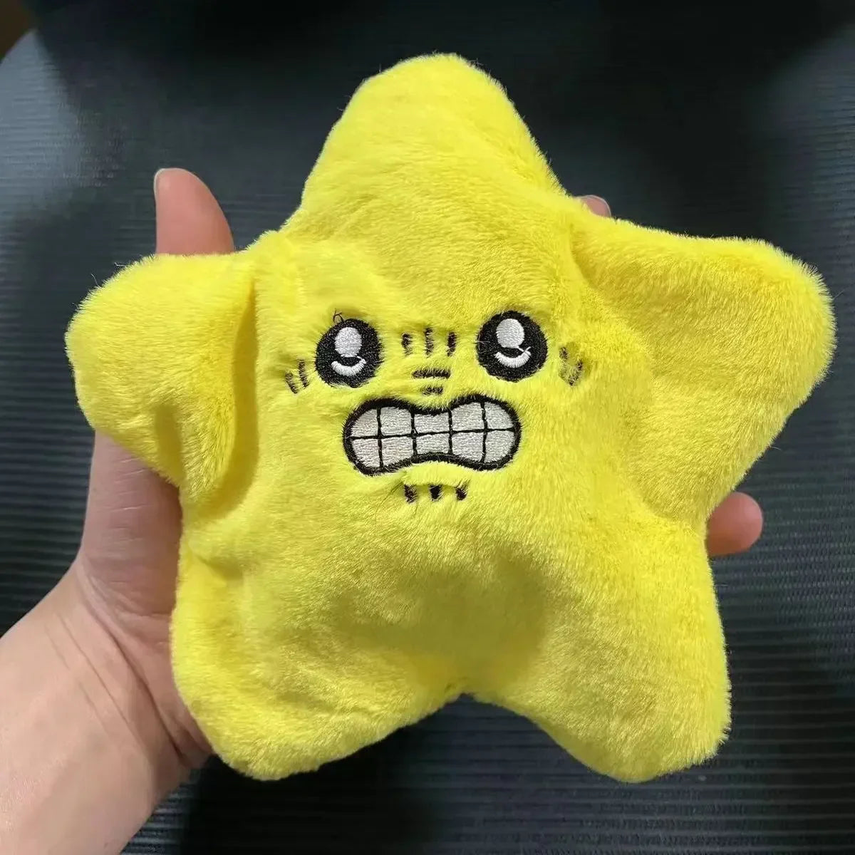 A bright yellow plush dancing stars plush toy with embroidered eyes grinning mouth doll backpack ornament