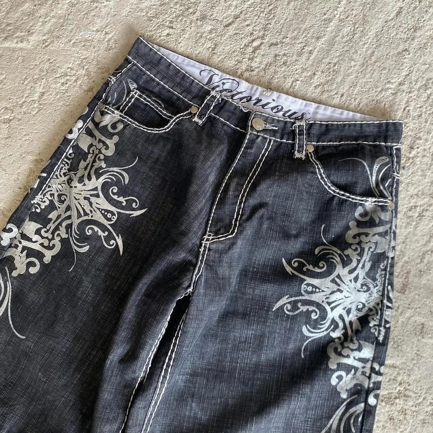 Dark denim basketball shorts y2k with intricate white hip hop heraldic embroidery and contrasting stitching on sides