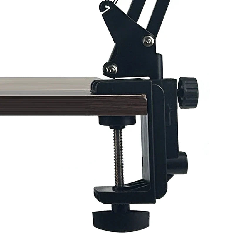 Black adjustable clamp with metal screw on wooden surface for desktop cantilever microphone stand suitable for bm800