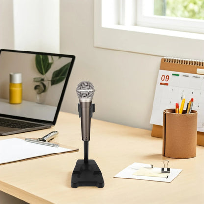 A sleek silver and black condenser microphone on a desktop microphone stand with adjustable height and spring clip fixation