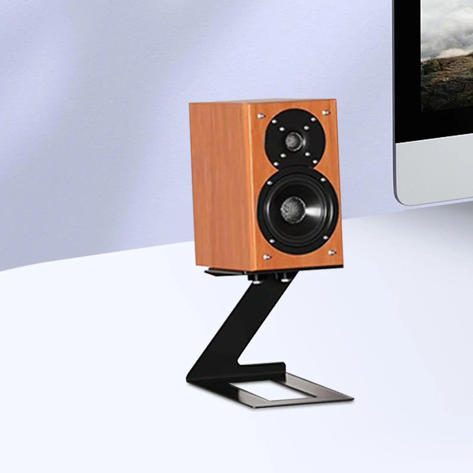 Wooden-finished bookshelf speaker with black drivers on a metal desktop speaker stand with vibration absorption pad for game room bookshelf