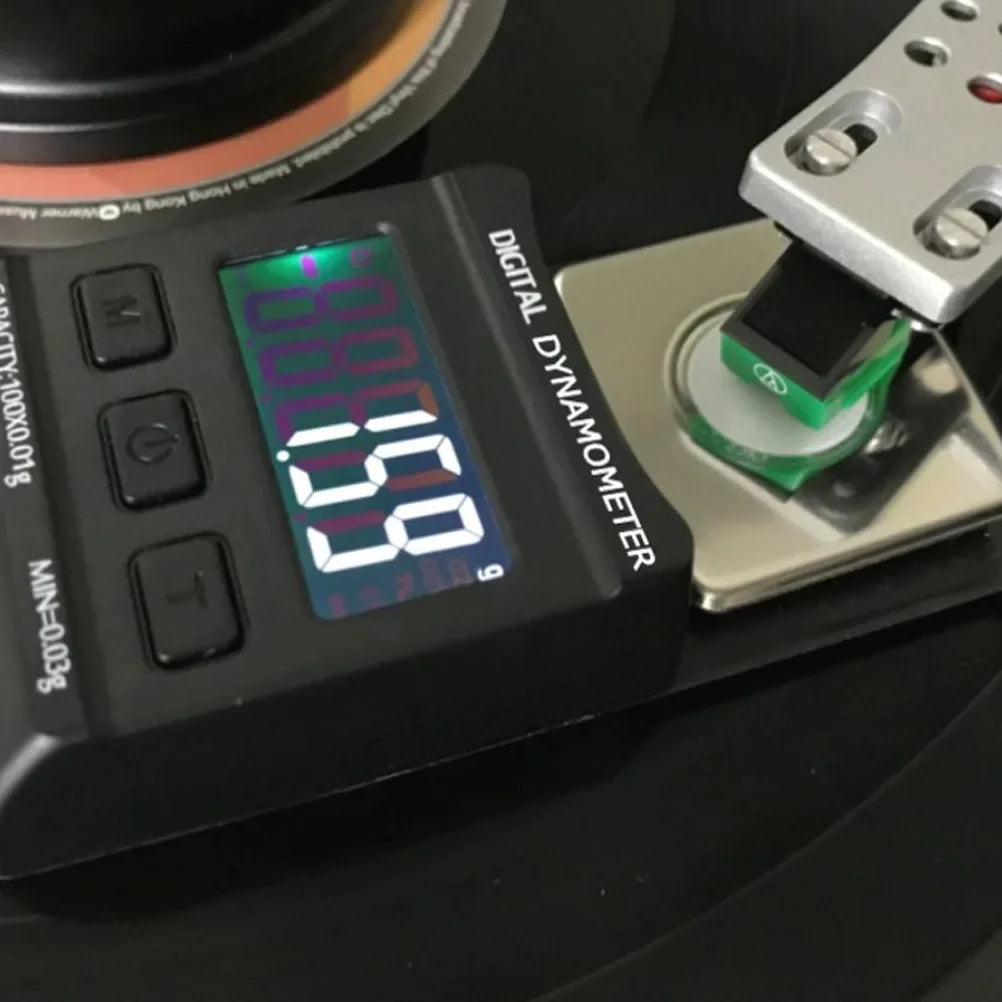 Black digital stylus force scale with large backlit screen displaying 0.88 for turntable needle pressure testing