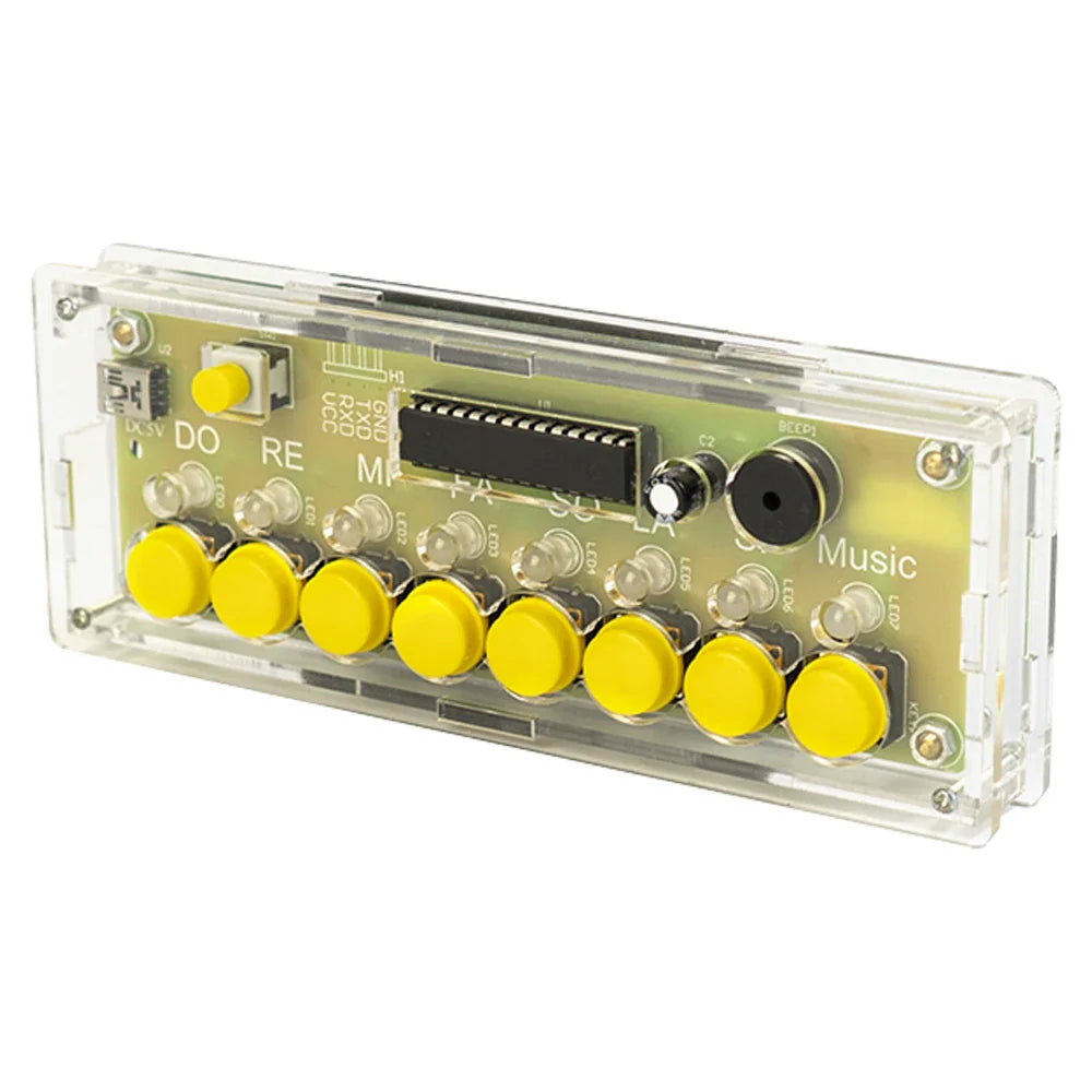 Clear plastic case housing green circuit board with eight yellow keys electronic piano buttons in electronic piano kit