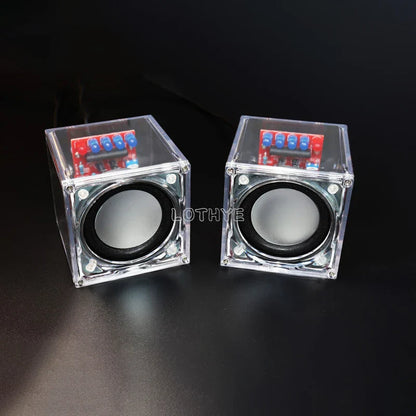 Clear cube-shaped diy mini speaker electronic kit with transparent electronic components and visible red circuit boards