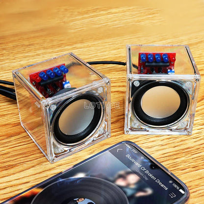 Clear cube-shaped diy mini speaker with transparent electronic components showing red and blue circuit boards for school fun