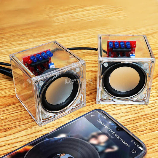 Clear cube-shaped diy mini speaker with transparent electronic components showing red and blue circuit boards for school fun