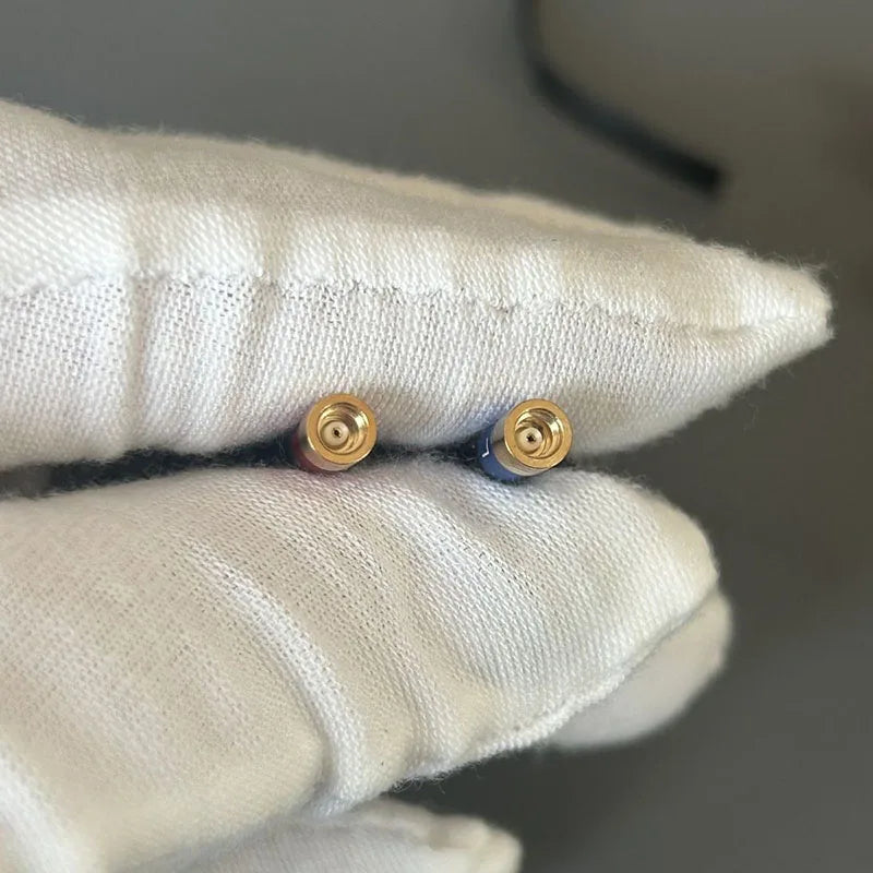 A pair of gold-toned cylindrical diy mmcx hifi ear studs with blue enamel accent for metal deep bass audiophile use