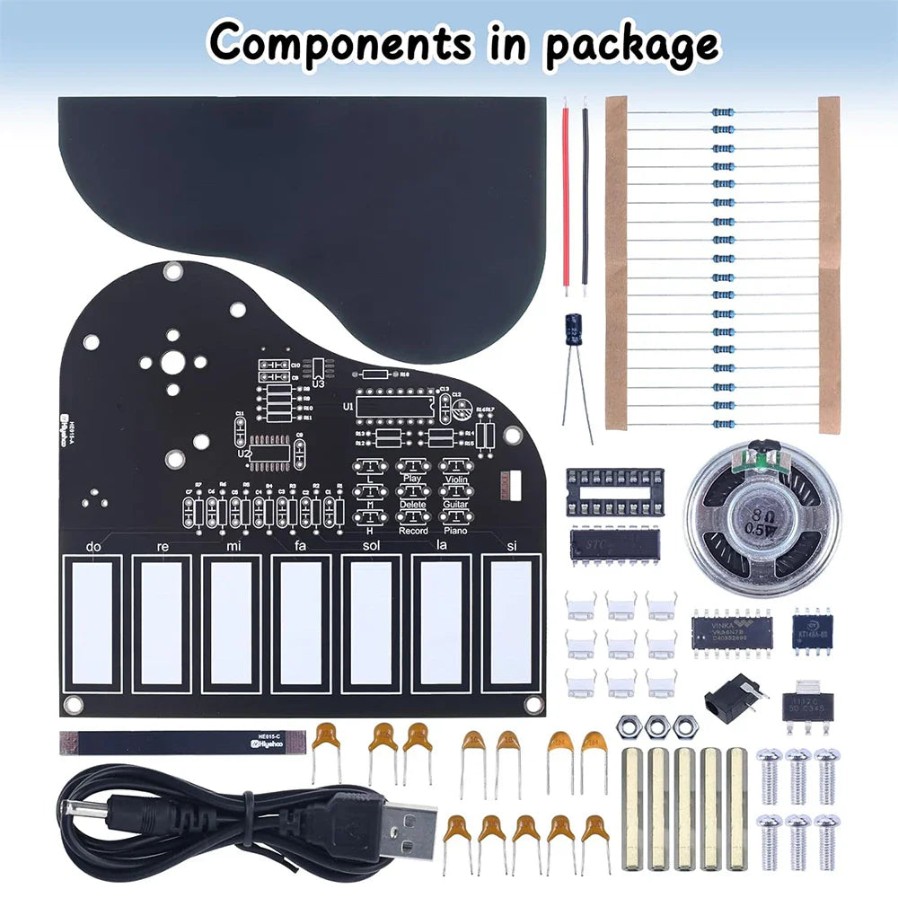 Black piano-shaped electronic soldering practice kit board with white labeled keys and press button for recorded music