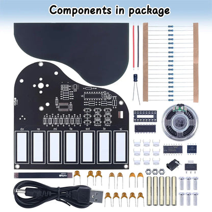 Black piano-shaped electronic soldering practice kit board with white labeled keys and press button for recorded music