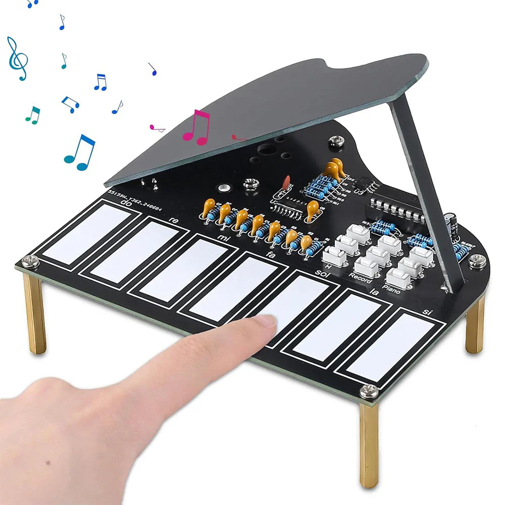 Black electronic piano practice kit with white keys gold legs transparent lid labeled notes for press button recorded music
