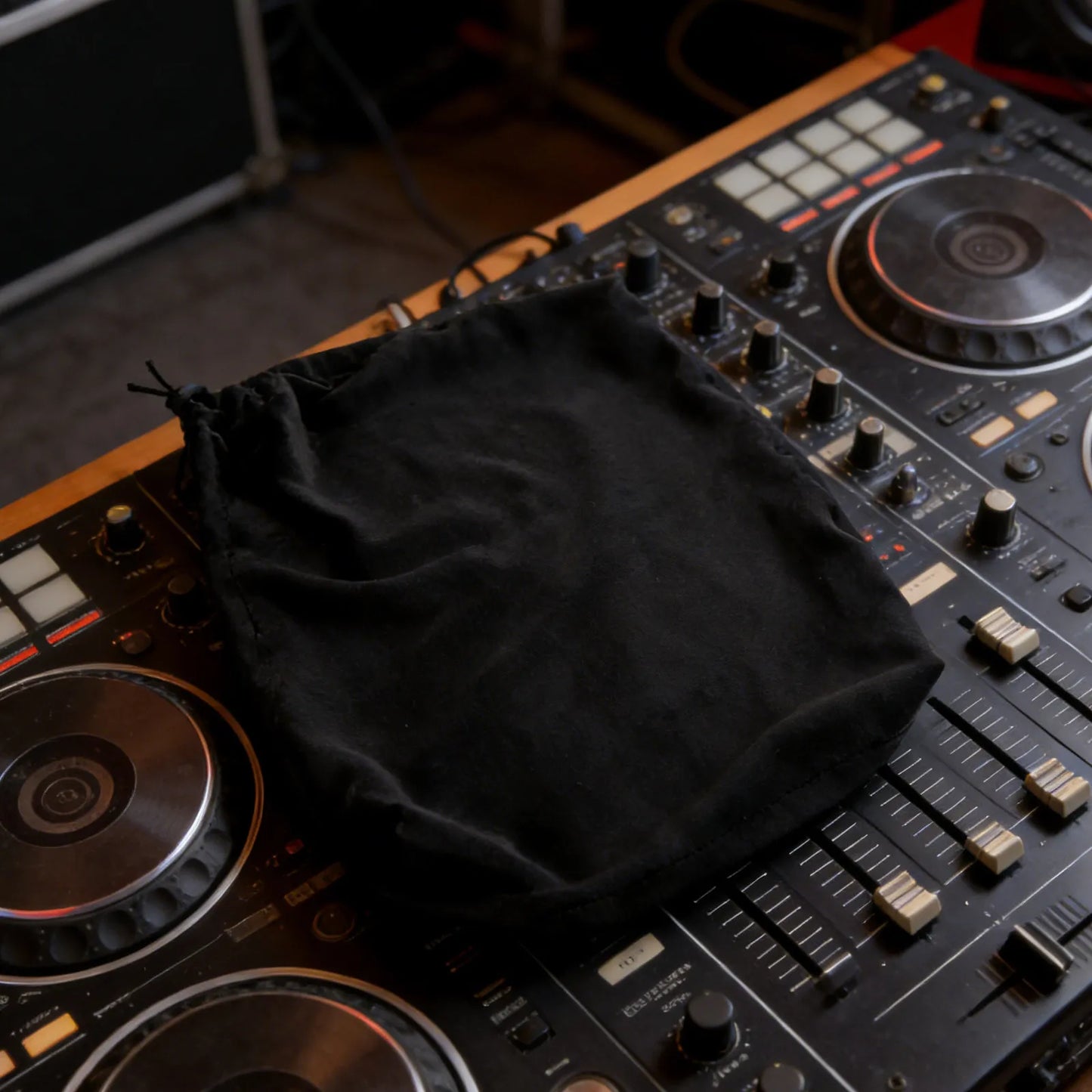 Black console dust guard stretchy drawstring bag on dj mixer providing sound mixer dustproof protection