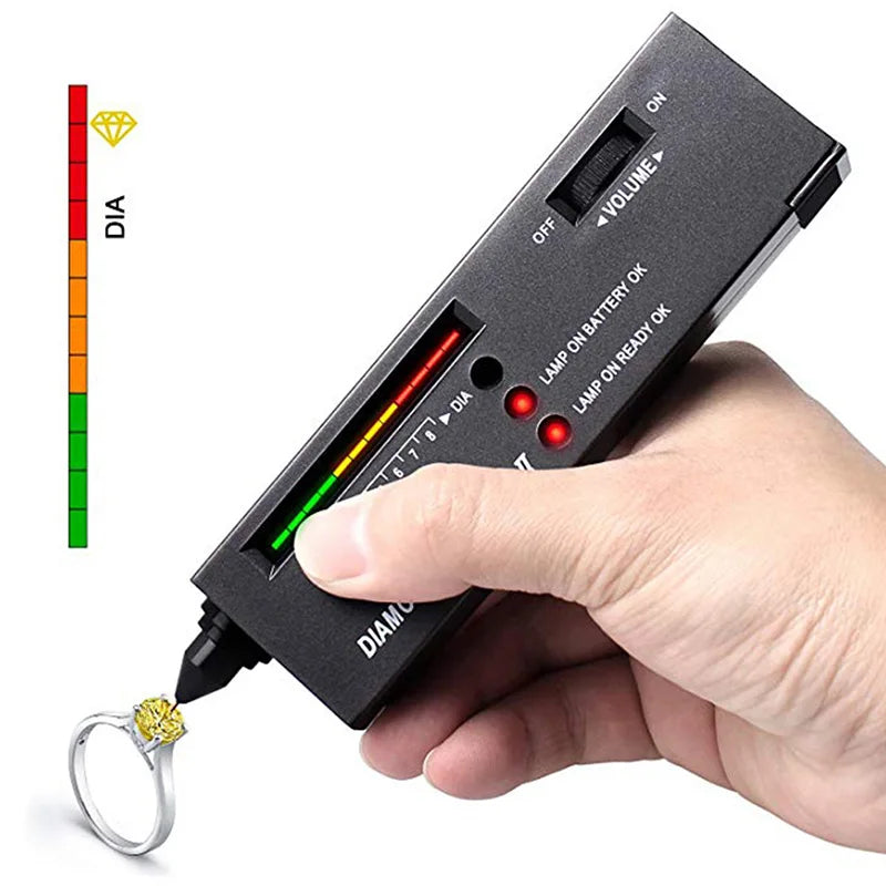 Black diamond tester with red and green illuminated display held near yellow gemstone ring using watcher tool led gemstone gem selector