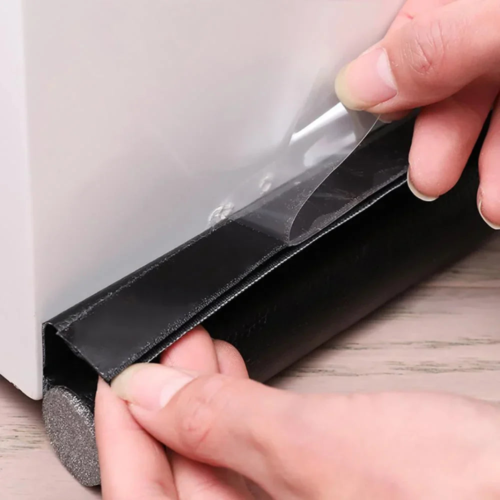 Black rubber door draft stopper with textured grippy surface and clear adhesive backing for sound-proof door gap blocking strip
