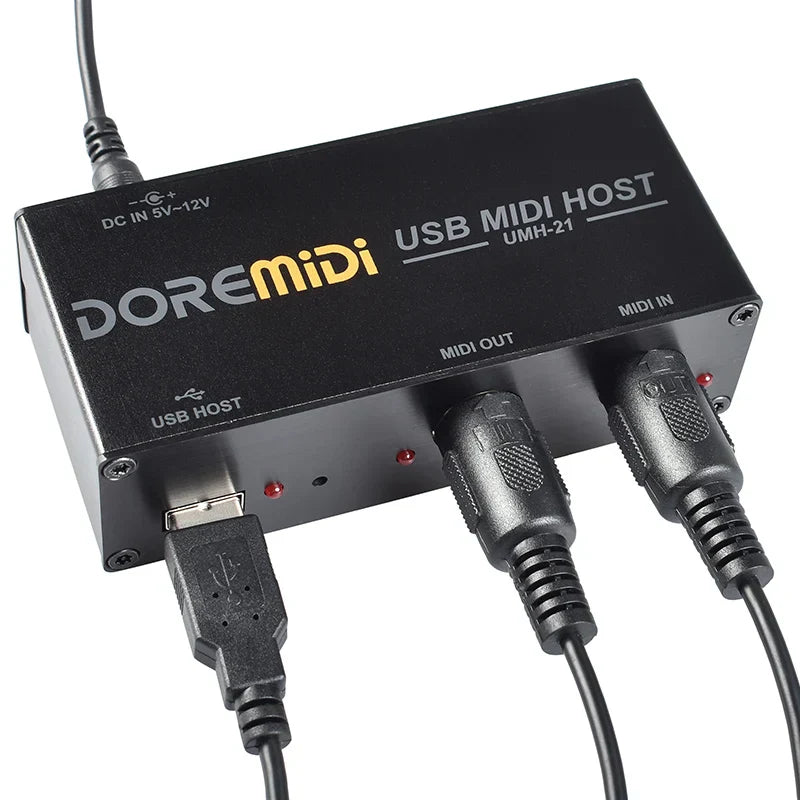 Black doremidi usb midi host box umh-21 with multiple ports, cables connected, and a visible indicator light on back side