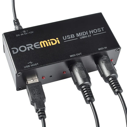 Black doremidi usb midi host box umh-21 with multiple ports, cables connected, and a visible indicator light on back side