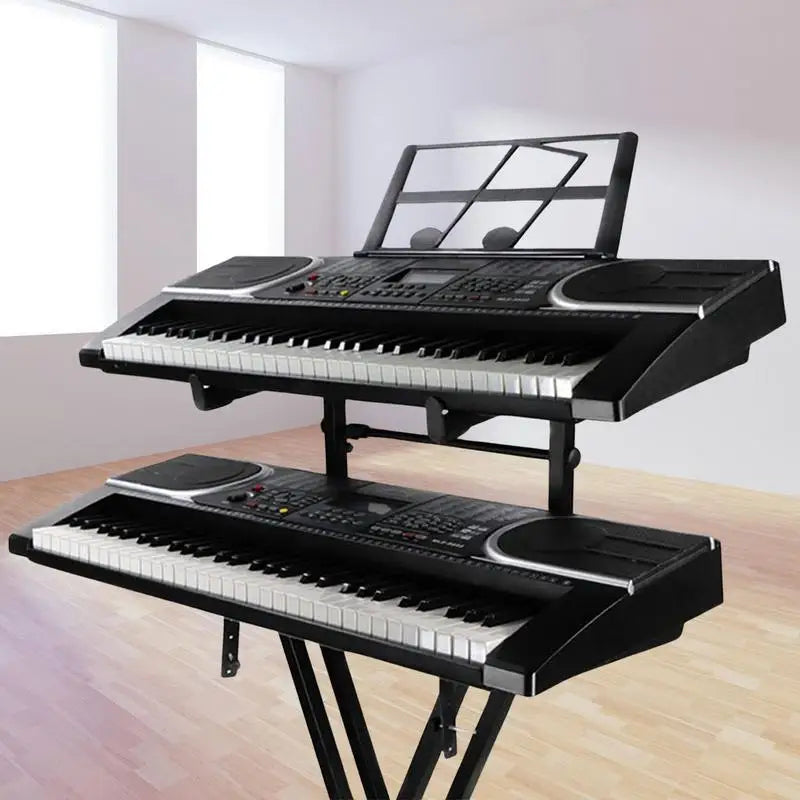 Black electronic keyboard with silver accents on a double keyboard stand x shaped piano display holder with locking straps heavy duty
