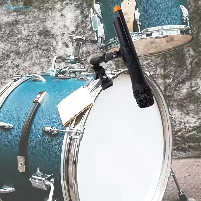 Black condenser drum microphone with orange top clip mounted on blue snare drum using microphone crab clamp thread mic clip