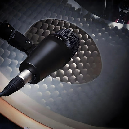 Black drum microphone e902 with mesh grille and plastick shell mounted on stand for crisp bass drum sounds