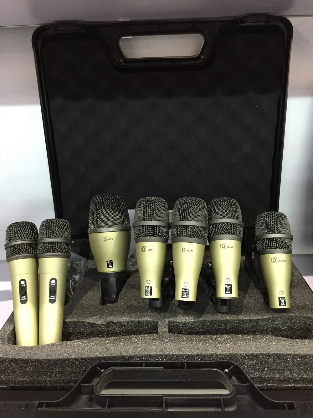 Set of six olive green drum microphone kit with black mesh grilles for 52q kick drum and 56q snare tom in foam case