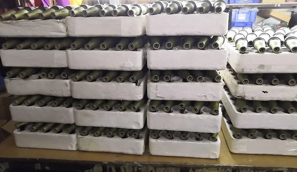 Stacks of olive-drab artillery shells in white foam packaging for drum microphone kit including 52q kick drum and 56q snare tom