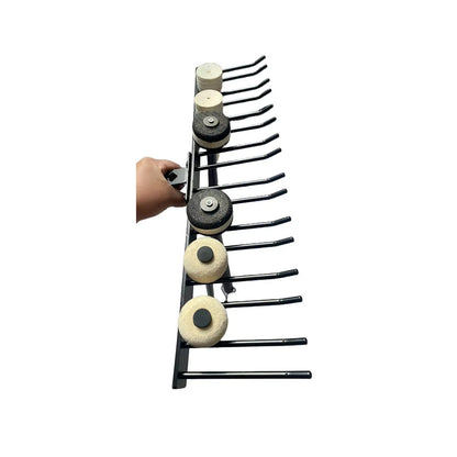 Black metal drumsticks display stand holding multiple circular abrasive pads with black and white centers for mallets wall mount