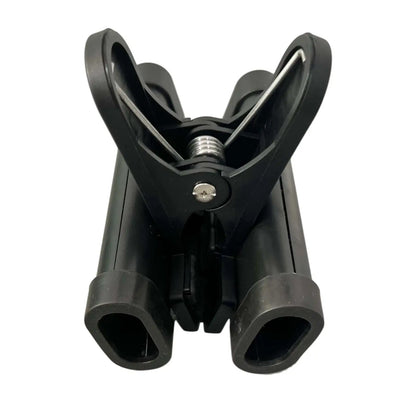 Black plastic drumstick holder with dual clips, central screw, and metallic spring drumstick clamp for cymbal stand use