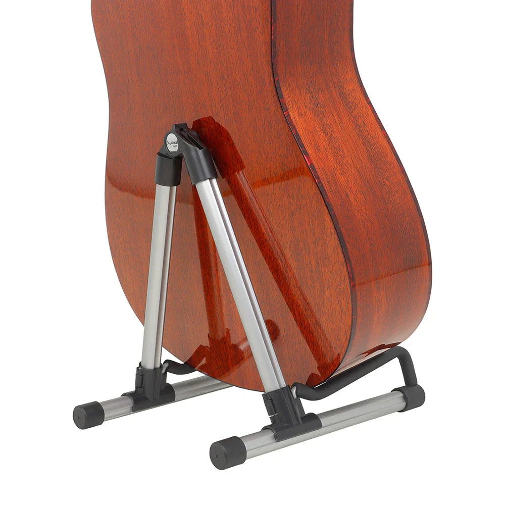 A durable guitar floor stand in silver and black with bracket display rack holding a mahogany acoustic instrument stringed music