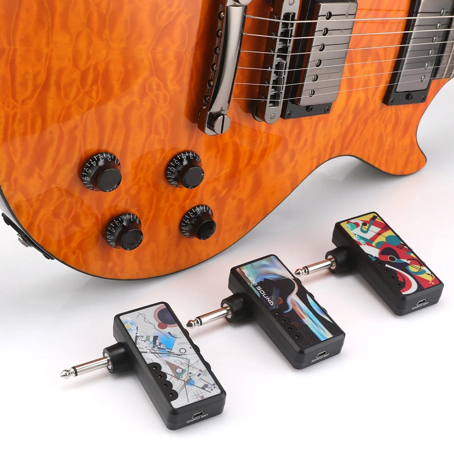 Three black wireless headphone amplifiers with colorful abstract designs featuring rechargeable battery mini usb for heavy metal use